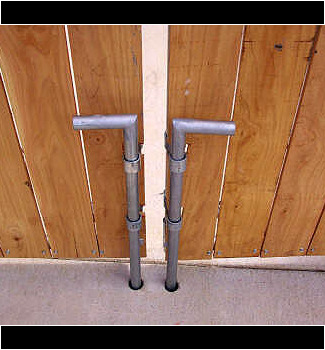 Drop rod on dumpster enclosure gates